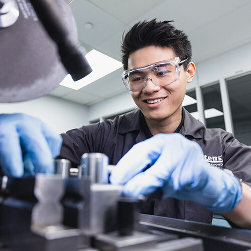 A U of T Engineering PEY Co-op student prepares a metal sample for analysis in the Materials Laboratory at Litens Automotive Partnership. (Photo by Neil Ta)